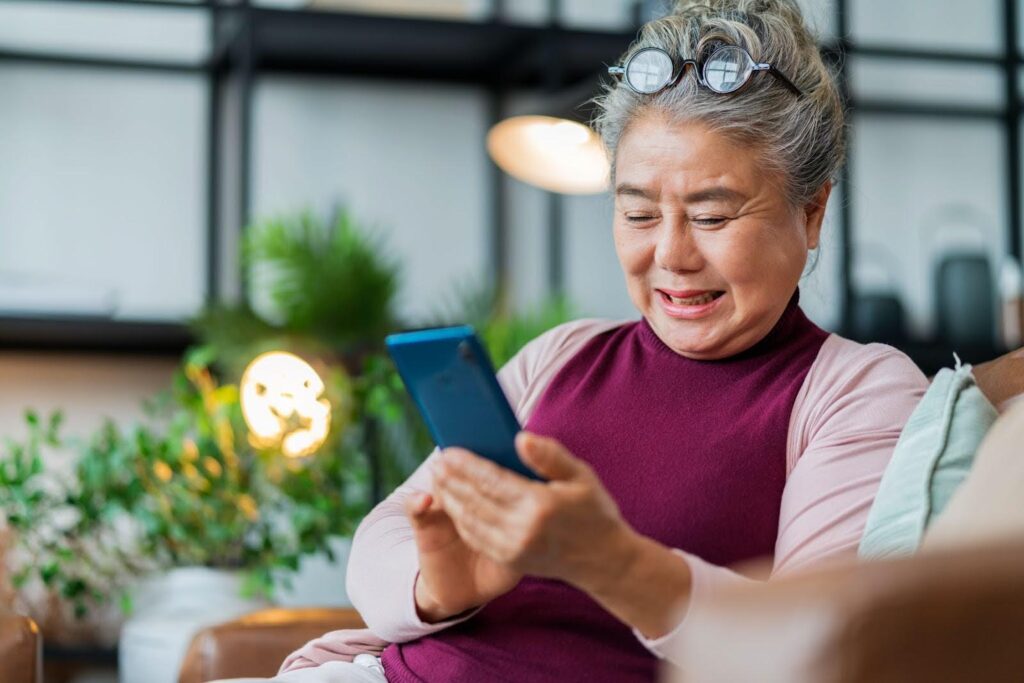 Senior woman happily talking with her AI companion at home
